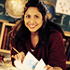 This is a photo of a young woman flipping through a notebook.