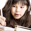 This is a photo of a girl writing in a notebook.